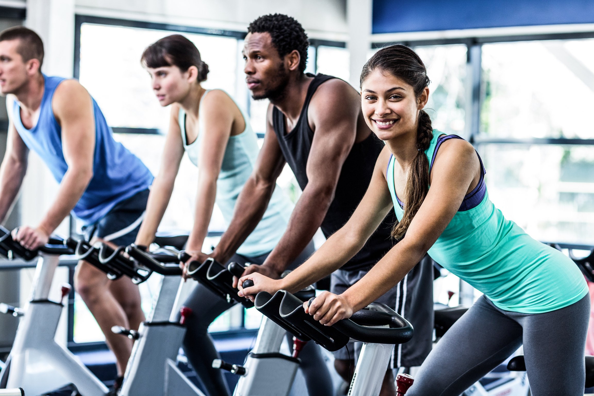 Fit people working out at spinning class